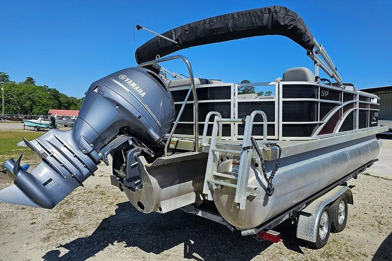 Slide: The Image of 2023 Bennington 21 SLX pontoon boat with Yamaha outboard motor on trailer. - 13