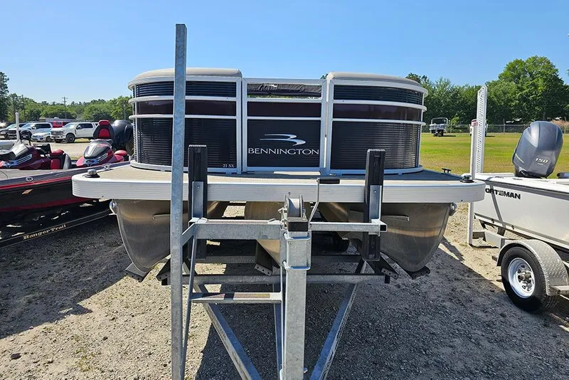 Slide: The Image of 2023 Bennington 21 SLX pontoon boat on trailer, parked outdoors. - 14