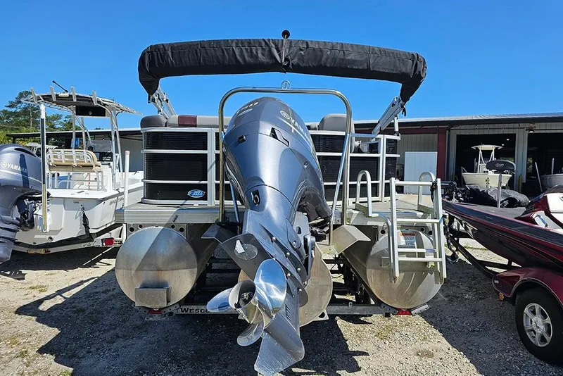 Slide: The Image of 2023 Bennington 21 SLX pontoon boat with Yamaha outboard motor, parked outdoors. - 19