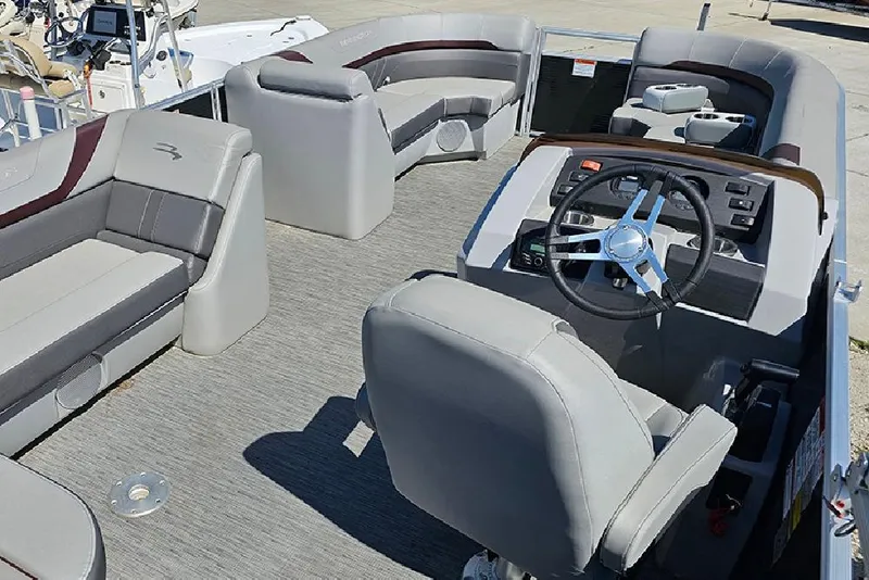 Slide: The Image of 2023 Bennington 21 SLX pontoon boat interior with plush seating and modern helm. - 21