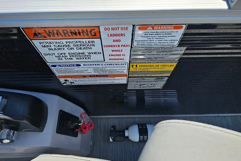 Slide: The Image of Warning labels on 2023 Bennington 21 SLX boat, highlighting safety and capacity guidelines. - 27