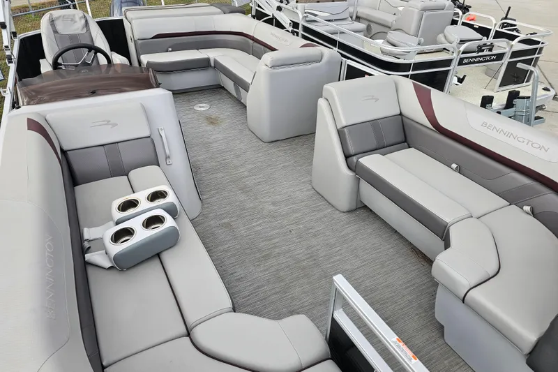 Slide: The Image of 2023 Bennington 21 SLX pontoon boat interior with luxurious seating and cup holders. - 6