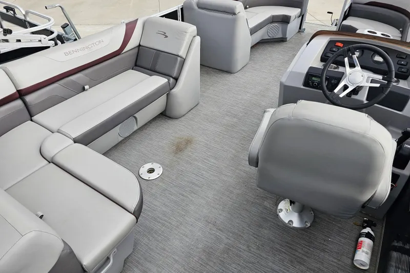 Slide: The Image of Interior of 2023 Bennington 21 SLX pontoon boat with gray seating and steering console. - 7