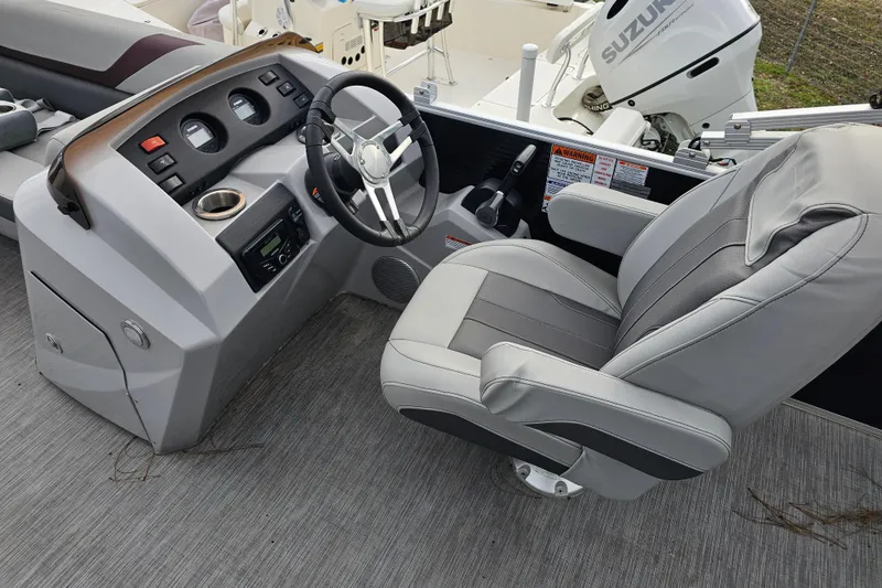 Slide: The Image of 2023 Bennington 21 SLX boat helm with steering wheel and captain's chair. - 8