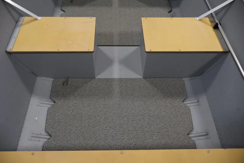 Slide: The Image of 2022 Lund SSV-16 Tiller interior with carpeted floor and wooden seats. - 12