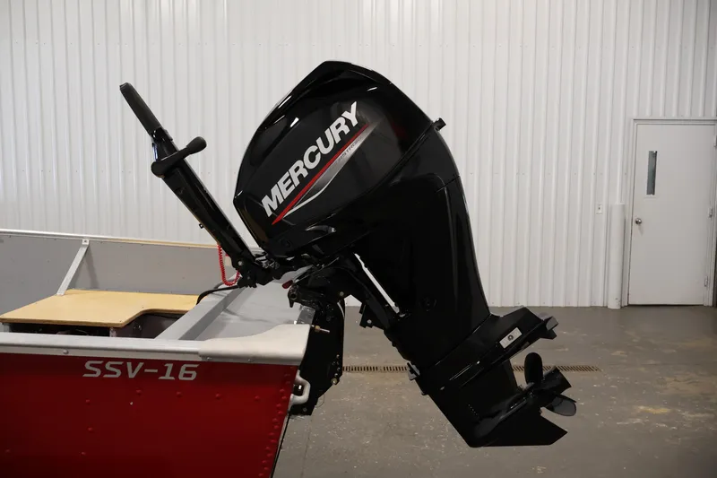 Slide: The Image of 2022 Lund SSV-16 Tiller boat with Mercury outboard motor in a garage setting. - 20