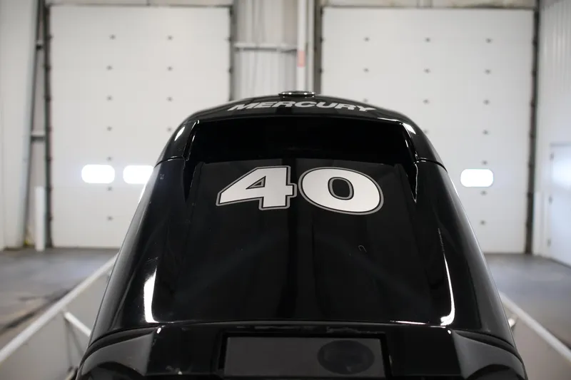 Slide: The Image of 2022 Lund SSV-16 Tiller with Mercury 40 HP engine in a garage setting. - 22