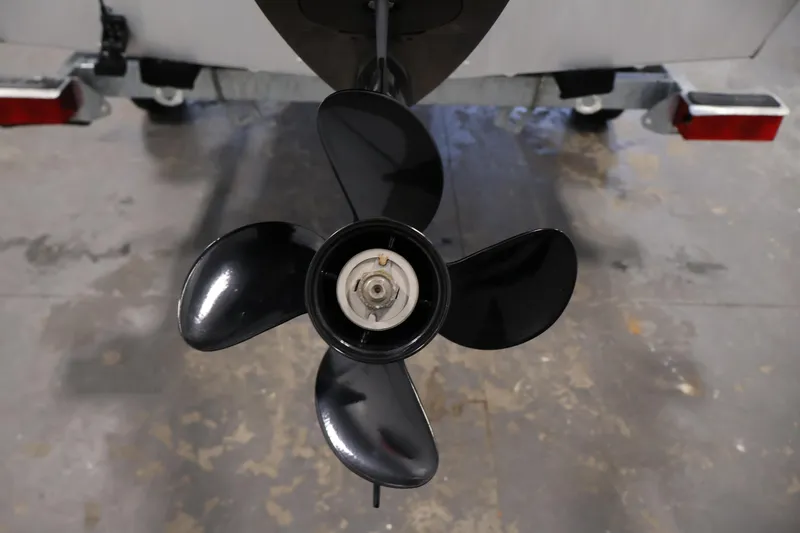 Slide: The Image of 2022 Lund SSV-16 Tiller boat propeller, close-up view in a garage setting. - 23