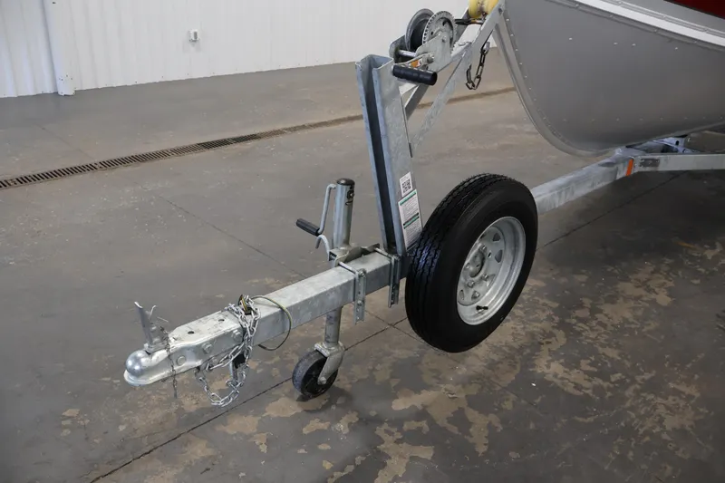 Slide: The Image of 2022 Lund SSV-16 Tiller boat trailer hitch and wheel in a garage setting. - 24