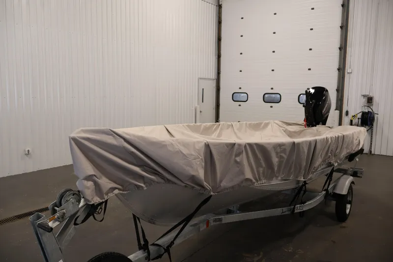 Slide: The Image of 2022 Lund SSV-16 Tiller boat covered in a garage setting. - 28