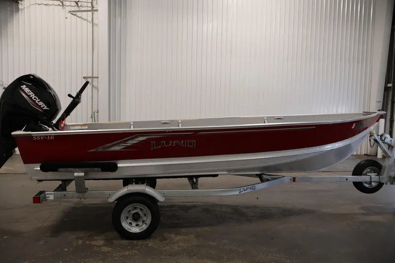 Slide: The Image of 2022 Lund SSV-16 Tiller boat on trailer, featuring a Mercury outboard motor. - 4