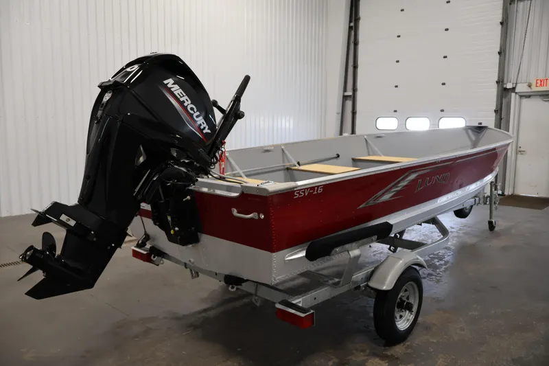 Slide: The Image of 2022 Lund SSV-16 Tiller boat with Mercury outboard motor in a garage. - 5