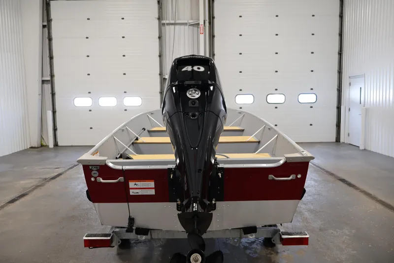 Slide: The Image of 2022 Lund SSV-16 Tiller boat with 40 HP motor in a garage setting. - 6