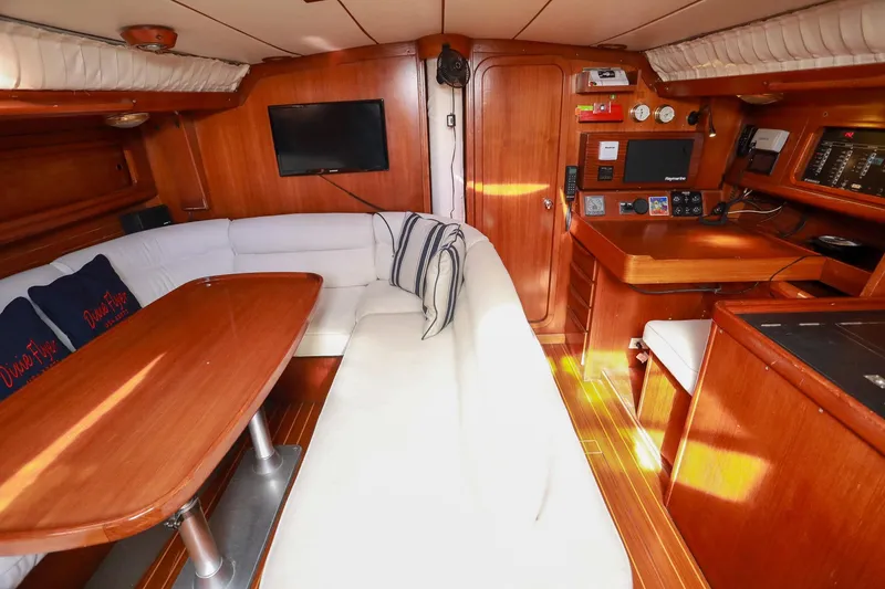 Slide: The Image of Luxurious interior of 1988 Grand Soleil 46 Jezequel yacht with wood finish and white seating. - 11