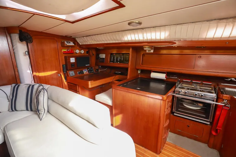Slide: The Image of Luxurious interior of 1988 Grand Soleil 46 Jezequel yacht with wooden furnishings and cozy seating. - 12
