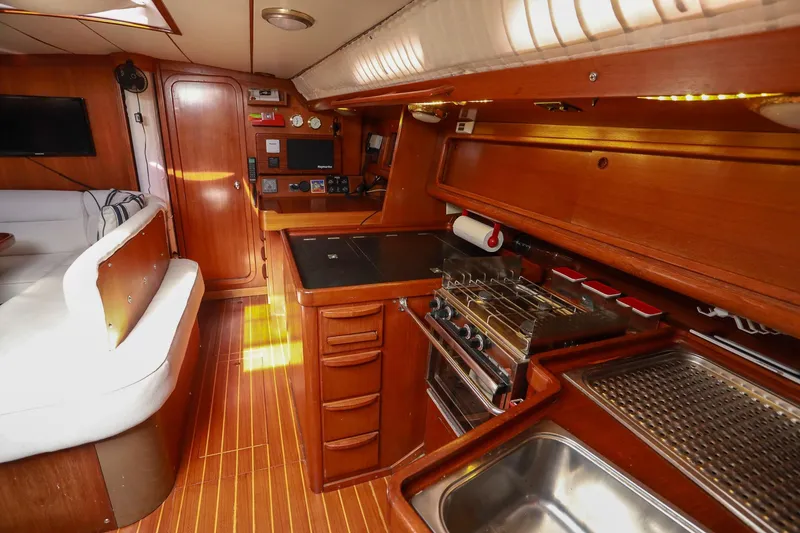 Slide: The Image of Interior of 1988 Grand Soleil 46 Jezequel yacht with navigation equipment and wooden cabinetry. - 16