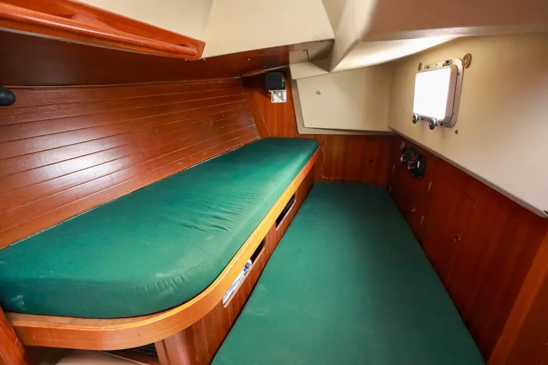 Slide: The Image of Interior of 1988 Grand Soleil 46 Jezequel yacht with wooden cabinetry and compact kitchen. - 18