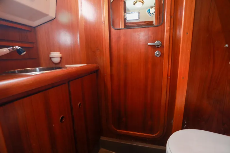 Slide: The Image of Cozy cabin interior of 1988 Grand Soleil 46 Jezequel with green cushions and wooden paneling. - 19
