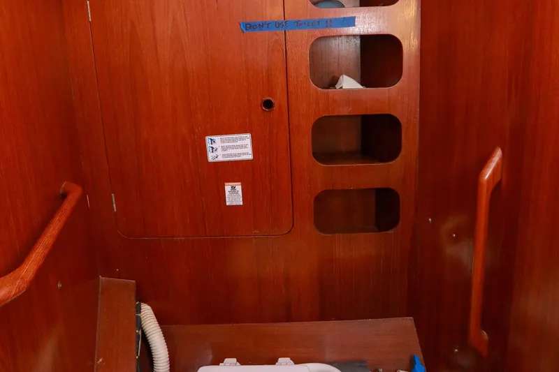 Slide: The Image of Interior of 1988 Grand Soleil 46 Jezequel yacht, featuring wooden cabinetry and mirrors. - 25