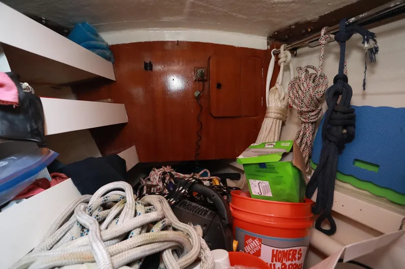 Slide: The Image of Interior of 1988 Grand Soleil 46 Jezequel yacht with wooden paneling and storage shelves. - 26