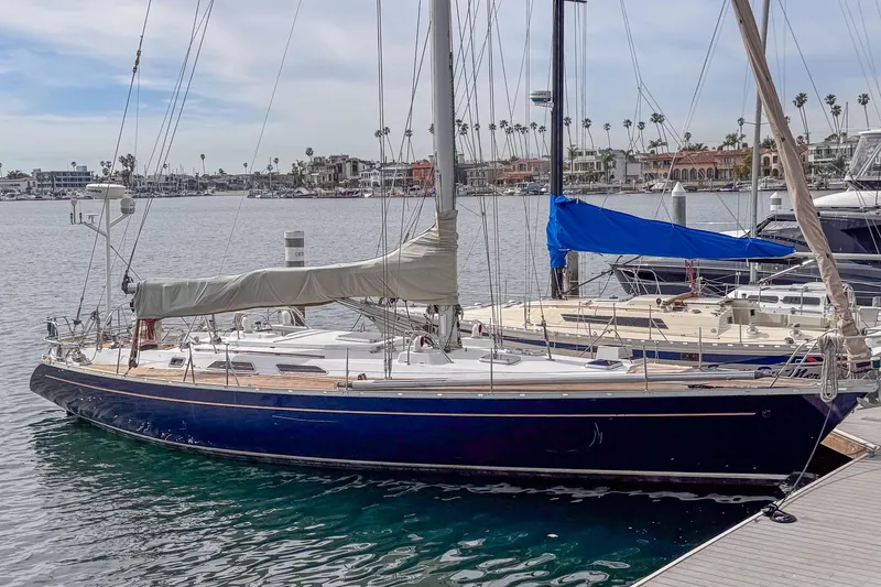 Slide: The Image of 1988 Grand Soleil 46 Jezequel sailboat docked in a marina, calm waters, clear sky. - 3