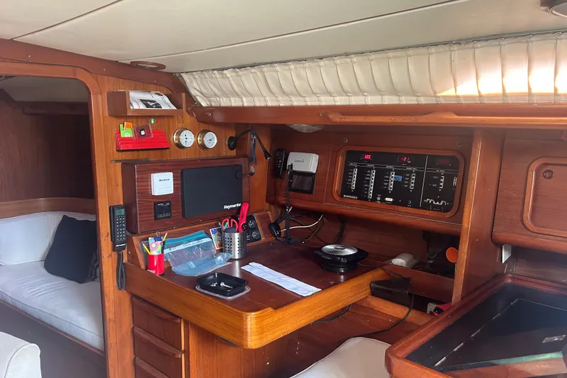 Slide: The Image of Navigation station inside 1988 Grand Soleil 46 Jezequel yacht, featuring control panels and instruments. - 41