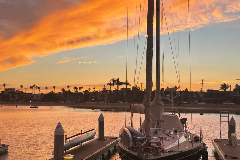 Slide: The Image of Grand Soleil 46 Jezequel 1988 sailboat docked at sunset with vibrant sky. - 45