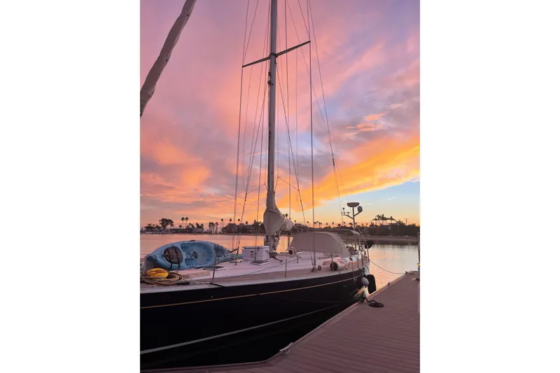 Slide: The Image of Sailboat Grand Soleil 46 Jezequel 1988 docked at sunset with vibrant sky. - 46