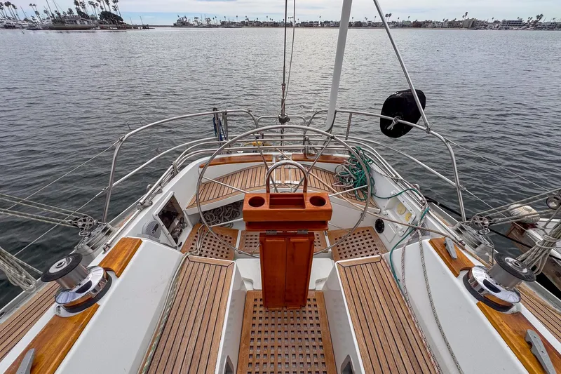 Slide: The Image of 1988 Grand Soleil 46 Jezequel sailboat docked at marina, blue hull, wooden deck. - 5