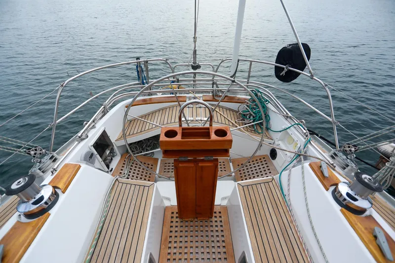 Slide: The Image of Stern view of 1988 Grand Soleil 46 Jezequel yacht with railing and water backdrop. - 9