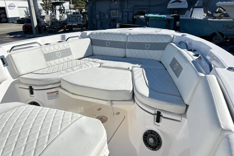 Slide: The Image of 2024 Sea Fox 268 Commander boat interior with white cushioned seating. - 2