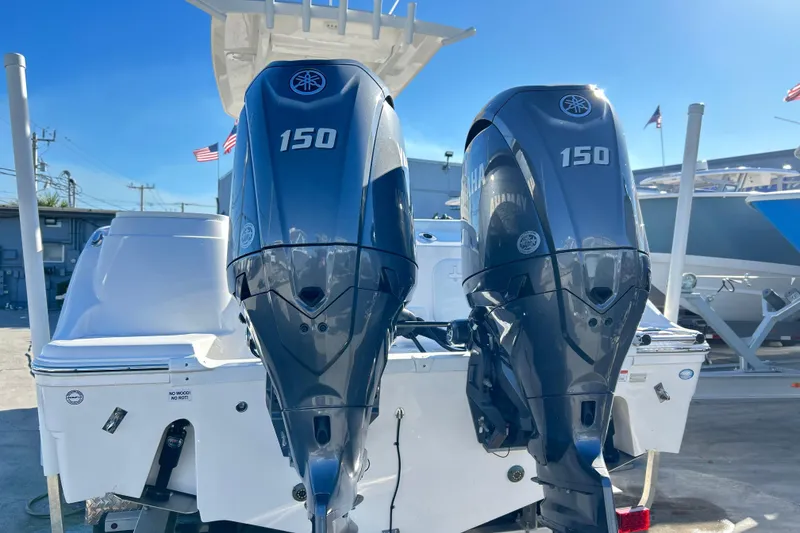 Slide: The Image of 2024 Sea Fox 268 Commander with dual Yamaha 150 outboard engines, docked under clear skies. - 25