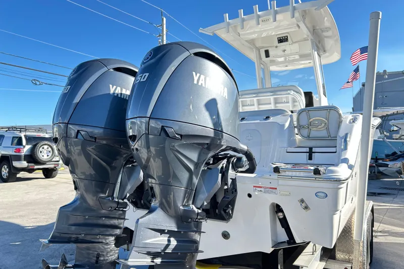 Slide: The Image of 2024 Sea Fox 268 Commander boat with dual Yamaha engines, docked under clear blue sky. - 26