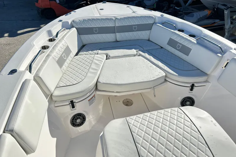 Slide: The Image of 2024 Sea Fox 268 Commander boat interior with cushioned seating and cup holders. - 3