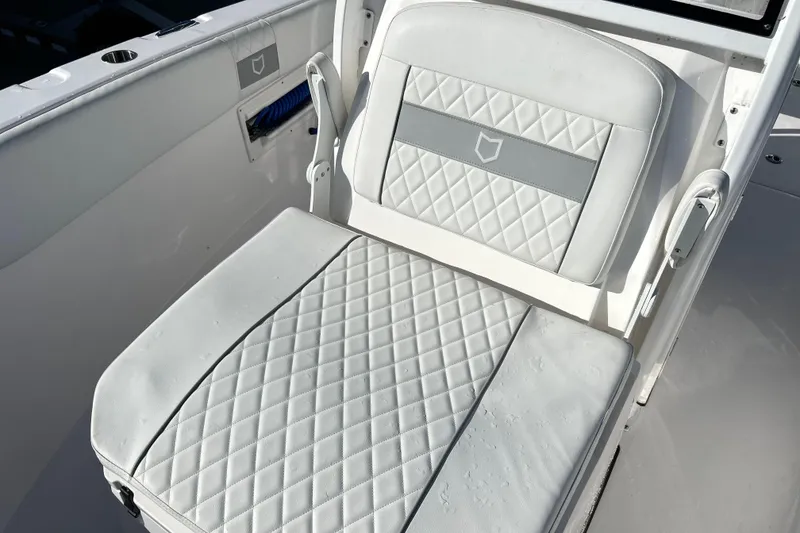 Slide: The Image of 2024 Sea Fox 268 Commander boat seat with diamond-pattern upholstery. - 5