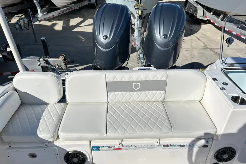 Slide: The Image of 2024 Sea Fox 268 Commander boat interior with dual engines and cushioned seating. - 6