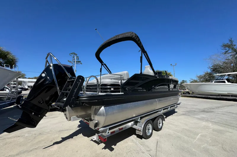 Slide: The Image of 2026 Bennington 22 MSB pontoon boat on trailer under clear blue sky. - 10
