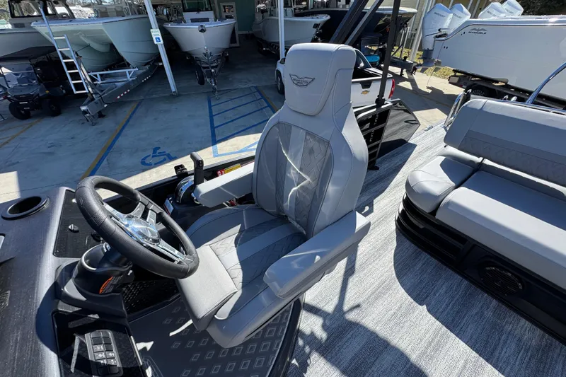 Slide: The Image of 2026 Bennington 22 MSB boat interior with steering wheel and seating area. - 23