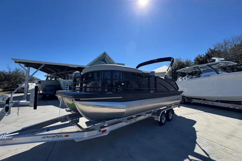 Slide: The Image of 2026 Bennington 22 MSB pontoon boat on trailer under clear blue sky. - 3