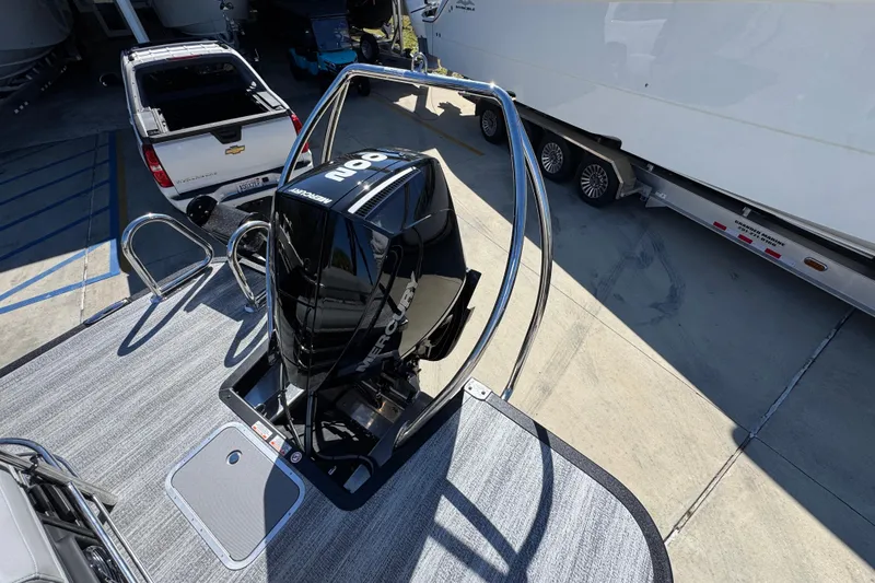 Slide: The Image of 2026 Bennington 22 MSB boat with Mercury outboard motor on a trailer. - 31