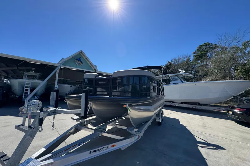 Slide: The Image of 2026 Bennington 22 MSB pontoon boat on trailer under bright sun. - 4