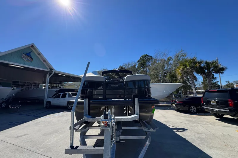 Slide: The Image of 2026 Bennington 22 MSB pontoon boat on trailer under clear blue sky. - 5