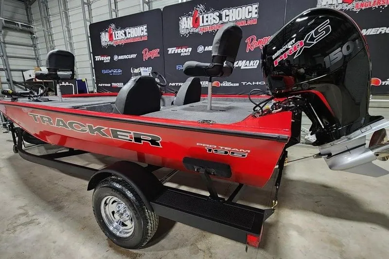 Slide: The Image of 2026 Tracker Pro Team 195 boat with Mercury engine in showroom setting. - 3