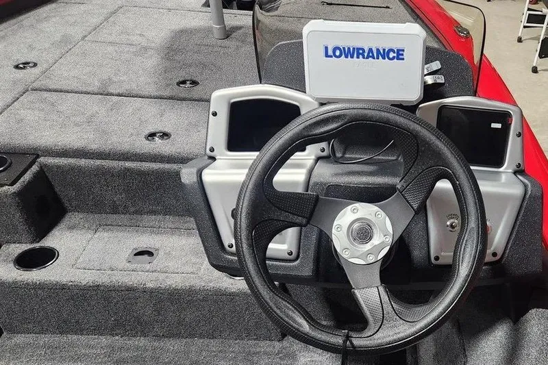 Slide: The Image of 2026 Tracker Pro Team 195 boat dashboard with steering wheel and Lowrance display. - 6