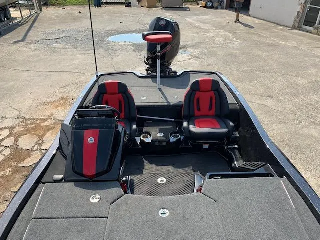 Slide: The Image of 2024 iKon LX20 boat interior with red and black seats, steering console, and motor. - 4