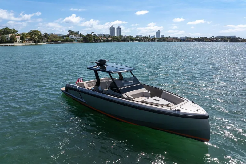 Slide: The Image of 2022 Vanquish VQ40 boat on calm water with city skyline in background. - 12