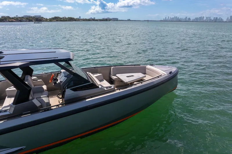 Slide: The Image of 2022 Vanquish VQ40 luxury yacht on calm waters with city skyline in background. - 17