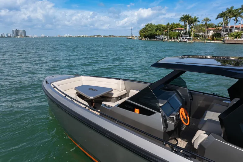 Slide: The Image of 2022 Vanquish VQ40 luxury yacht on serene water with modern design and spacious seating. - 19