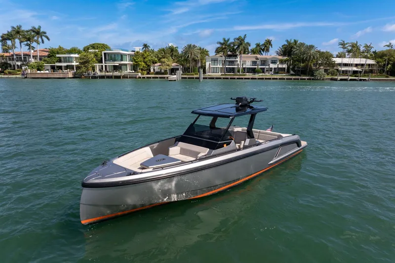 Slide: The Image of 2022 Vanquish VQ40 boat on water, luxury waterfront homes in background. - 3