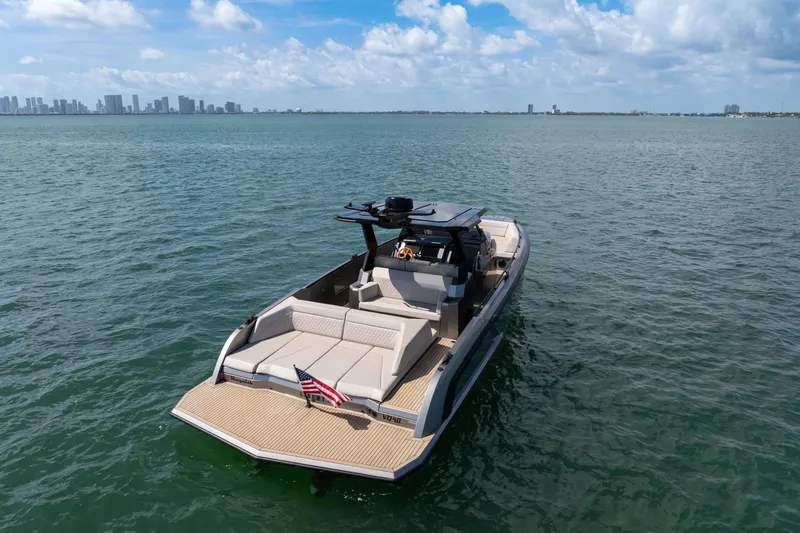 Slide: The Image of 2022 Vanquish VQ40 luxury yacht on open water with city skyline in background. - 37